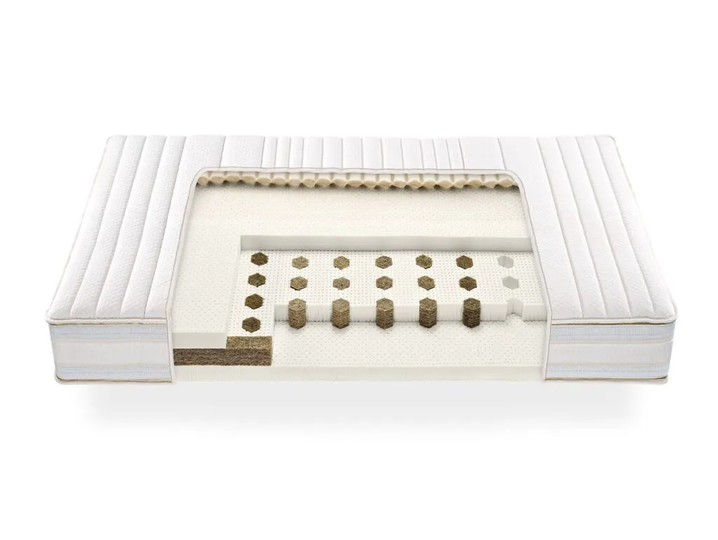 Die Talalay-Latexmatratze "DreamOn" zeichnet sich durch sichtbare Innenschichten aus Spiralen und Polstern aus, die ihre hochwertige Verarbeitung unterstreichen. Ein weißer, gesteppter Bezug sorgt für einen luxuriösen Touch.