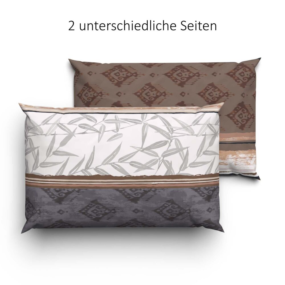 Abgebildet sind zwei Kissen, die jeweils eine andere Seite zeigen. Eine Seite zeigt ein braunes und dunkles Muster, das von Bettwäsche Lotus Sabri inspiriert ist; die andere Seite hat ein helles Muster mit grauen Blättern und Streifen. Der Text darüber lautet "2 unterschiedliche Seiten.