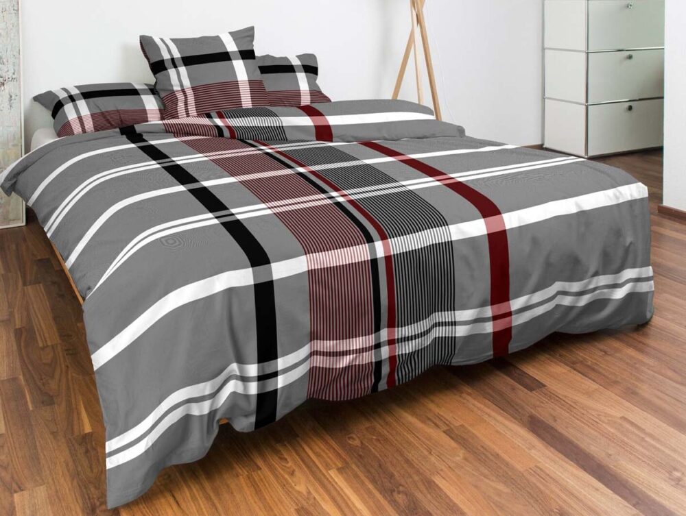 Ein modernes Schlafzimmer mit Holzfußboden verfügt über ein ordentlich gemachtes Bett mit Bettwäsche Nobilium Marius, einem Bettbezug und Kissenbezügen in grau, schwarz, weiß und rot kariert. Minimalistische Einrichtungsgegenstände vervollständigen den Look.