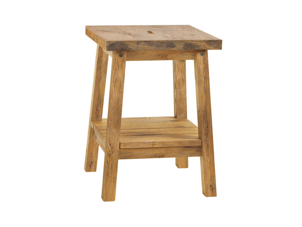 Ein kleiner, rustikaler Holzhocker mit vier Beinen, einer quadratischen Sitzfläche und einer unteren Ablage. Das Holz hat eine natürliche Oberfläche mit sichtbarer Maserung und Ästen, die ihm einen Vintage-Look verleihen.