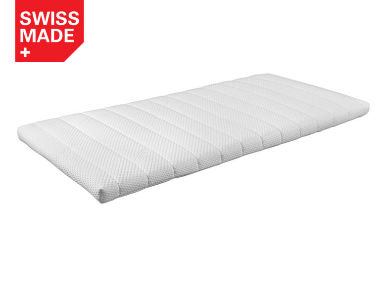 Eine weiße, rechteckige Matratzenauflage mit einer strukturierten, gesteppten Oberfläche. In der oberen linken Ecke befindet sich ein rotes Etikett mit der Aufschrift SWISS MADE und einem weißen Kreuz. Der Hintergrund ist einfarbig weiß.