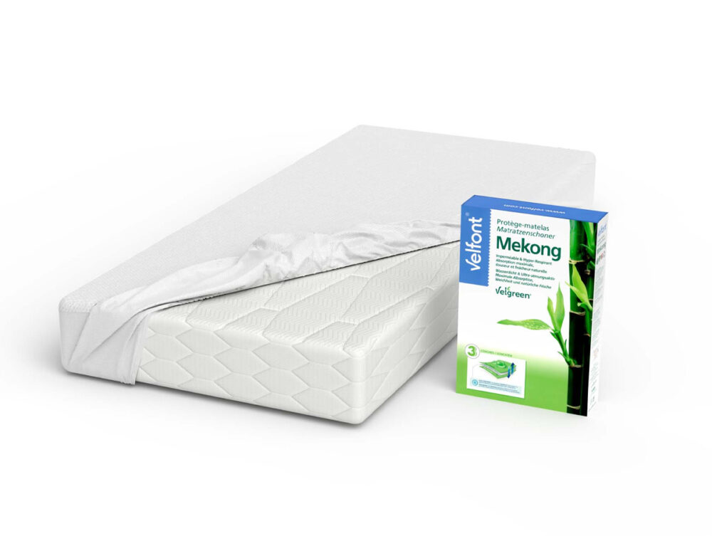 Eine weiße Matratze mit einem teilweise entfernten Matratzenschoner neben einer Schachtel mit der Aufschrift Velfont Mekong und einer grünen Bambusgrafik.