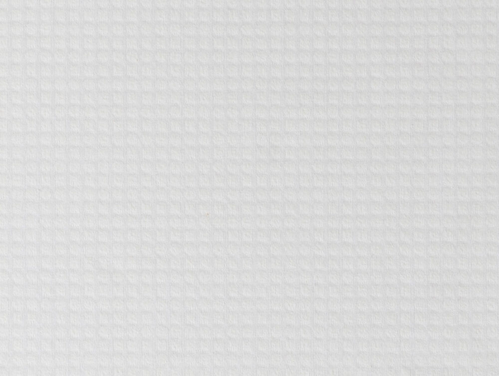 Eine Nahaufnahme des Velfont Kopfkissens "Viscofresh" Thermoregulierend zeigt seine weiße, strukturierte Oberfläche mit einem dezenten, gleichmäßig beleuchteten Gittermuster.