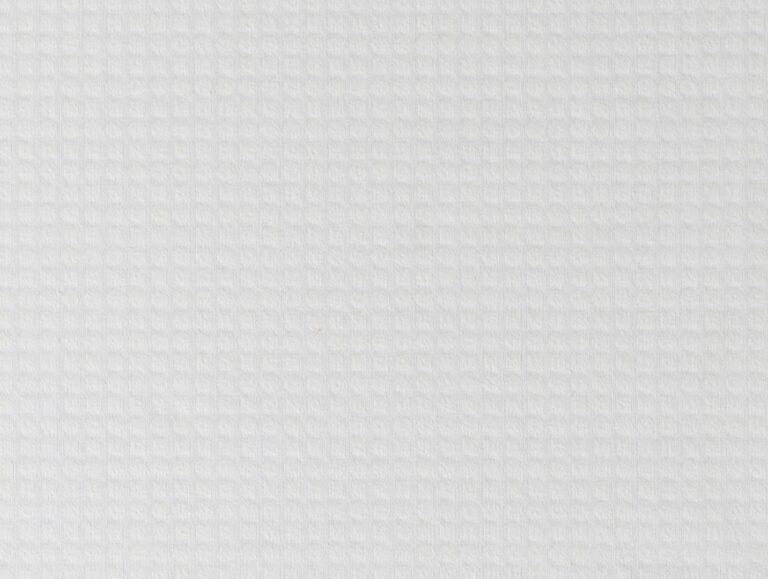 Eine Nahaufnahme des Velfont Kopfkissens "Viscofresh" Thermoregulierend zeigt seine weiße, strukturierte Oberfläche mit einem dezenten, gleichmäßig beleuchteten Gittermuster.