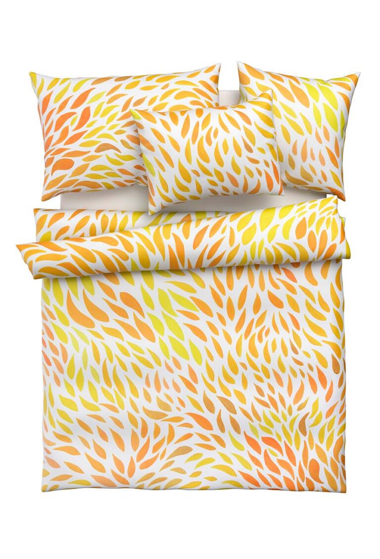Ein Bettwäscheset mit Kissenbezügen und einem Bettbezug mit einem lebhaften Muster aus gelben, orangefarbenen und hellbraunen blattähnlichen Formen auf weißem Hintergrund.